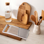 Side view of stainless steel vegetable and fruit slicer with sharp blade