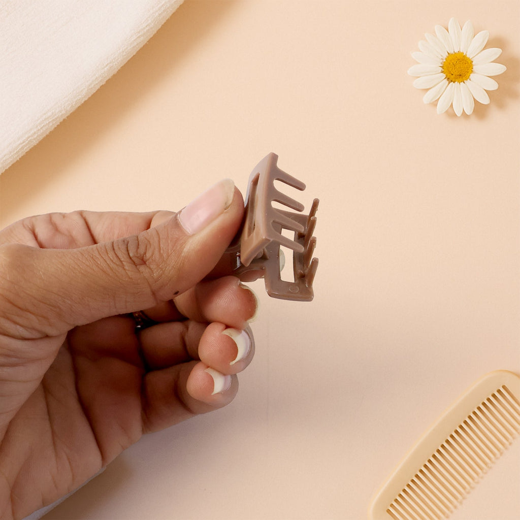 Neutral color mini hair claw clip holding small hair section