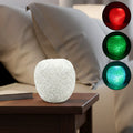 LED crystal table lamp with colour-changing ambient glow on a bedside table