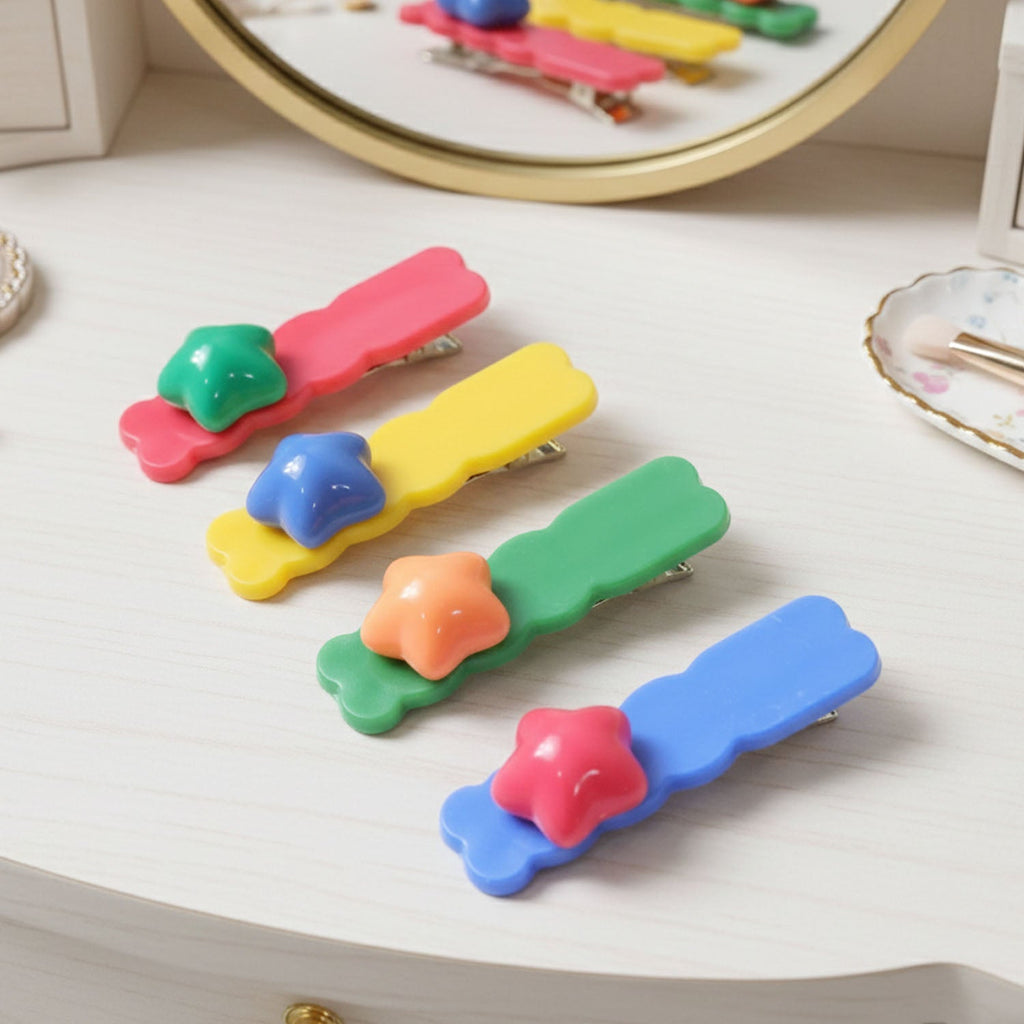 Multiple colourful star shaped hair clips displayed for fashion use