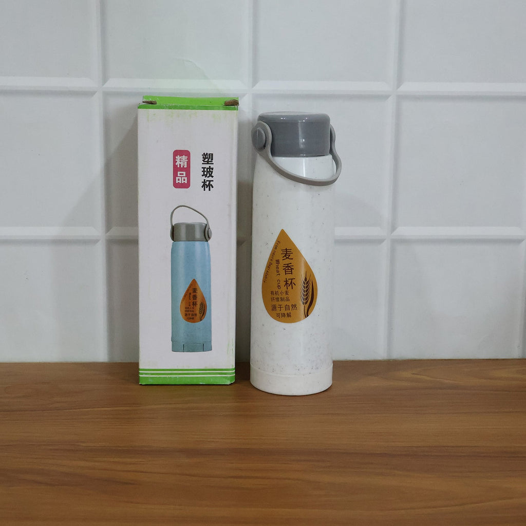 Lifestyle shot of glass water bottle on office desk