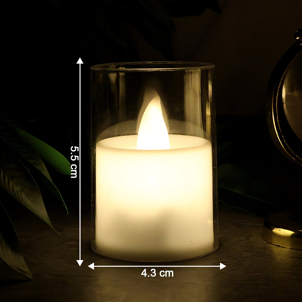 Flickering LED tealight candle glowing warmly in glass holder