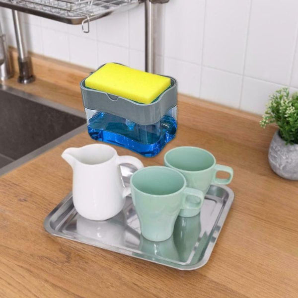 The 2-in-1 soap dispenser with sponge holder displayed on a clean kitchen sink area.