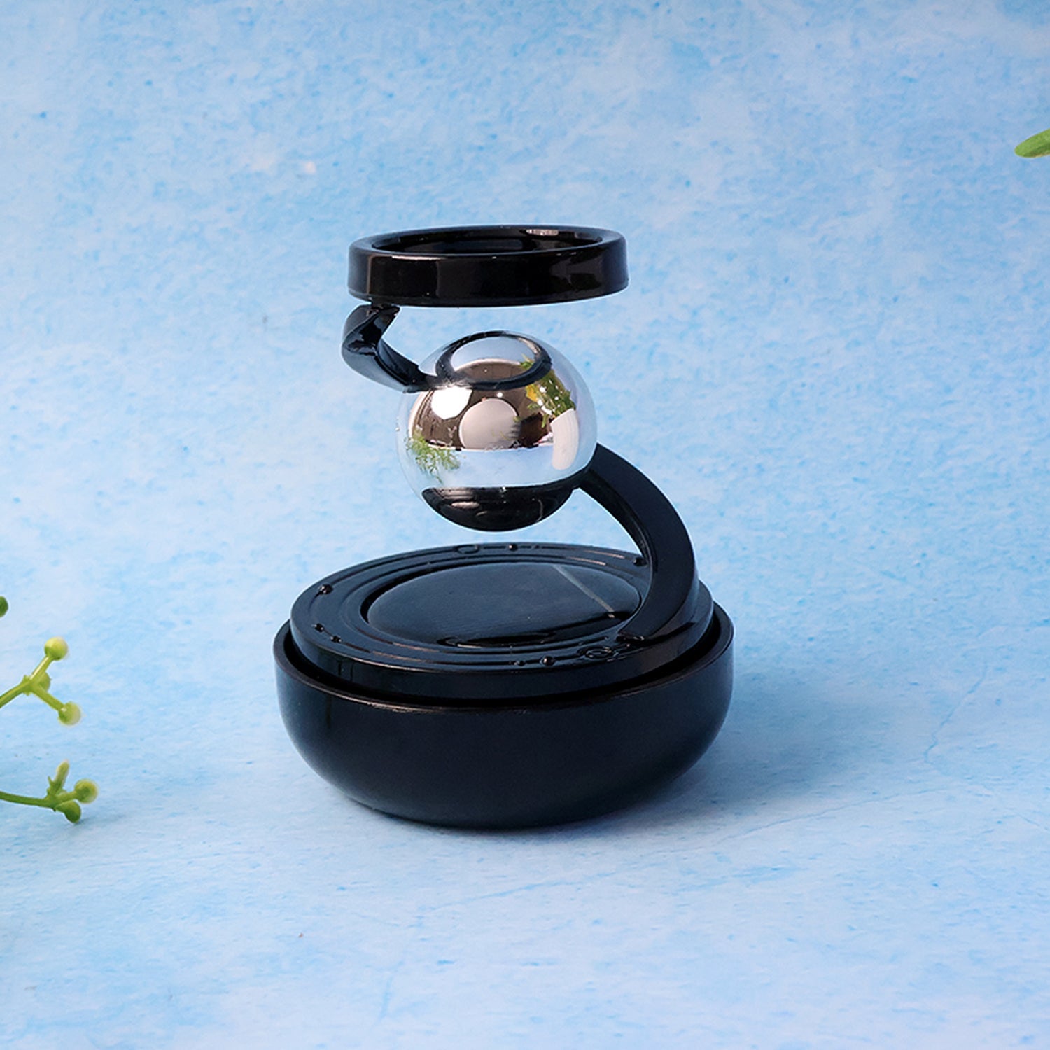 Interior car accessory featuring solar-powered rotating air freshener