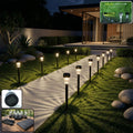 Solar powered lawn pathway light set illuminating garden pathway