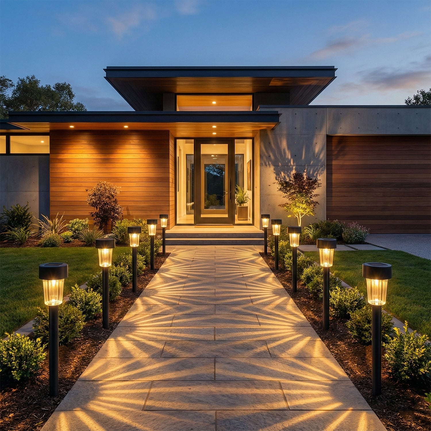 Landscape with solar powered lawn pathway lights glowing at night