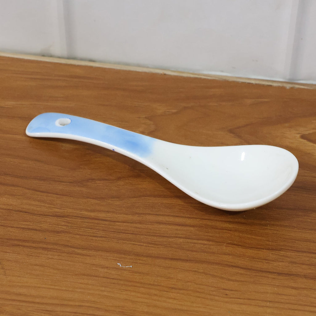 Heat-resistant ceramic spoon being used to serve food
