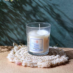 Decorative glass jar candle on a wooden table, enhancing home decor.