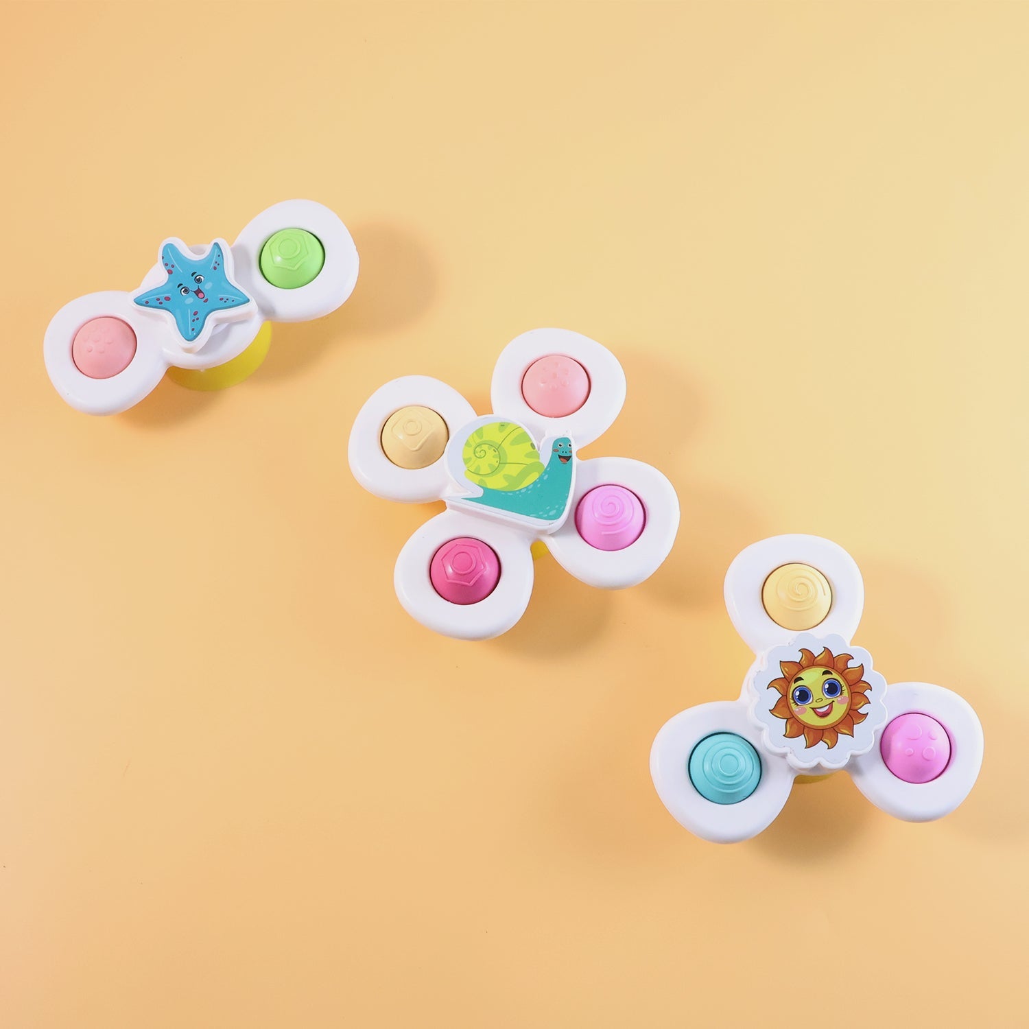 Close-up of white baby spinners with textured push buttons for tactile stimulation