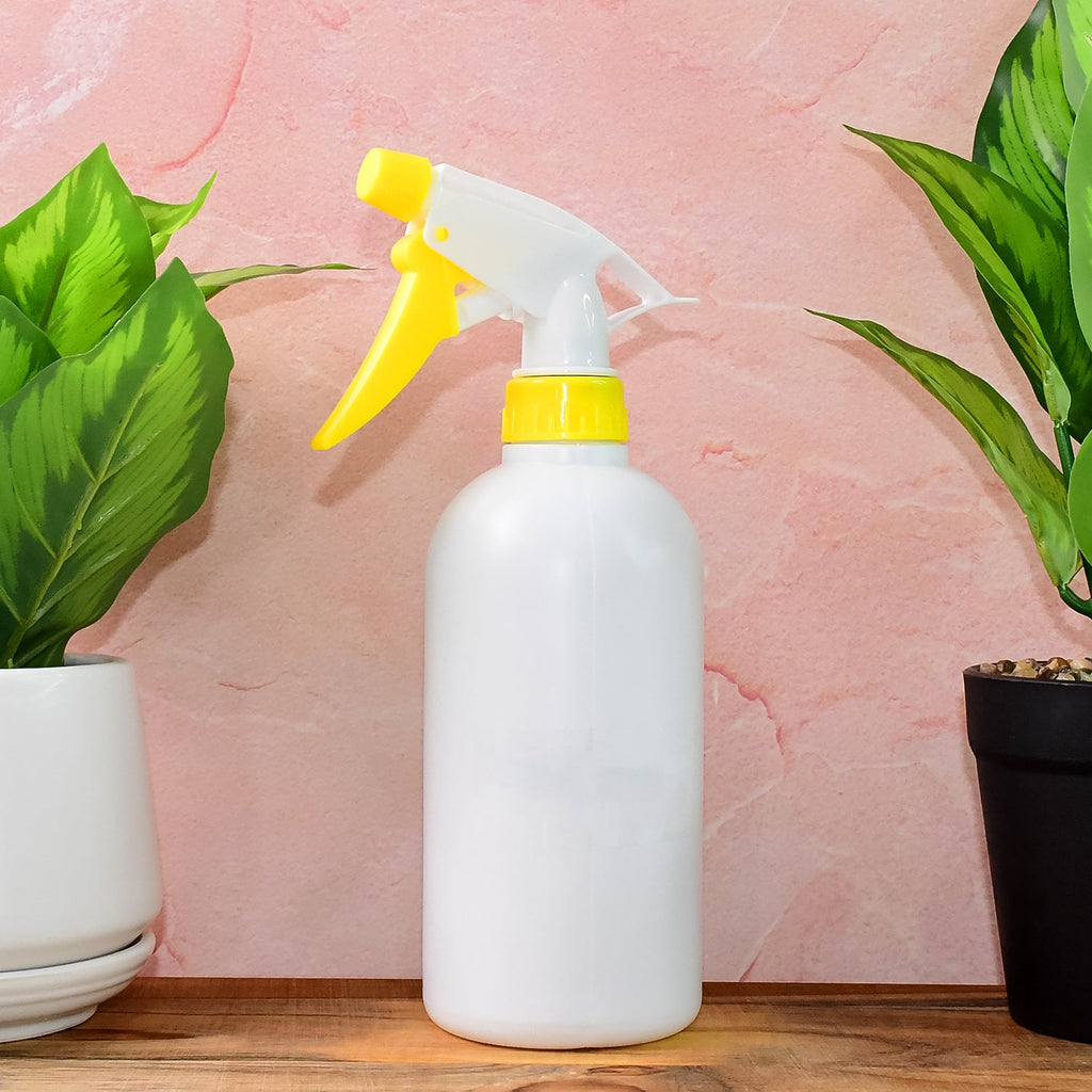 Close-up of ergonomic trigger nozzle on floral plastic spray bottle 500ml for fine mist spray