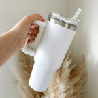 White insulated stainless steel travel tumbler displaying handle feature