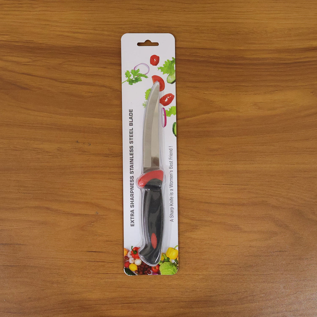 Stainless steel kitchen utility knife being used in the kitchen
