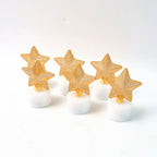 Top-down view showing a glowing LED star candle with flickering light