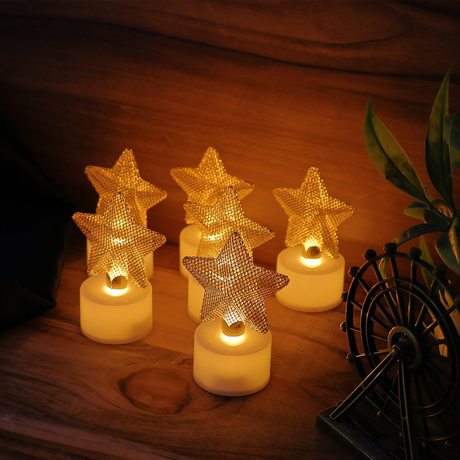 Group of LED star candles emitting soft, flickering warm glow