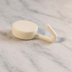 Stick-on round wall hooks mounted firmly on a clean wall