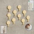 Set of 10 self adhesive round wall hooks arranged neatly for home organization
