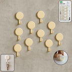 Set of 10 self adhesive round wall hooks arranged neatly for home organization