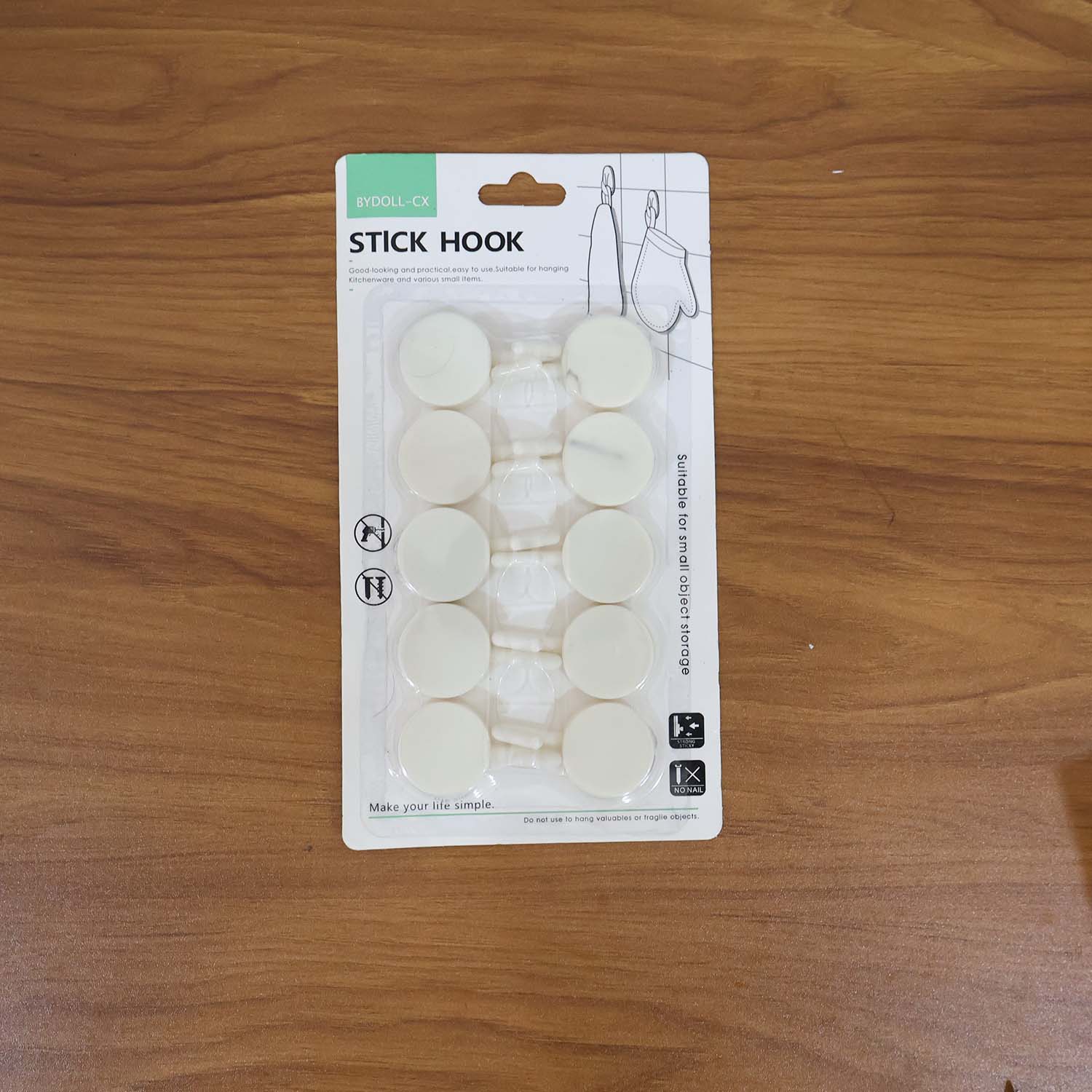 Practical use of self adhesive round wall hooks on a home wall