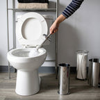 Toilet brush in use, reaching under the toilet rim for deep cleaning
