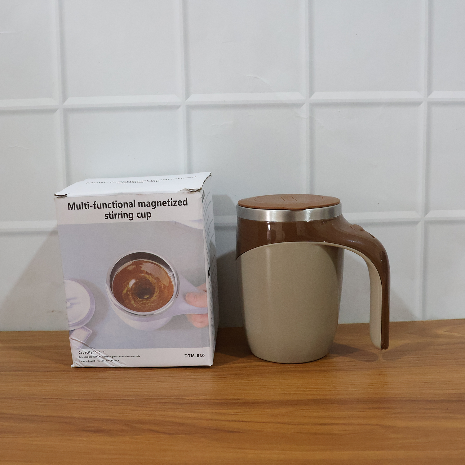 A person holding the self-stirring coffee mug, demonstrating its comfortable grip and portability.