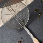 Oil draining skimmer spoon for safe frying and cooking