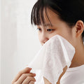 Compact disposable travel towel shown folded before use.