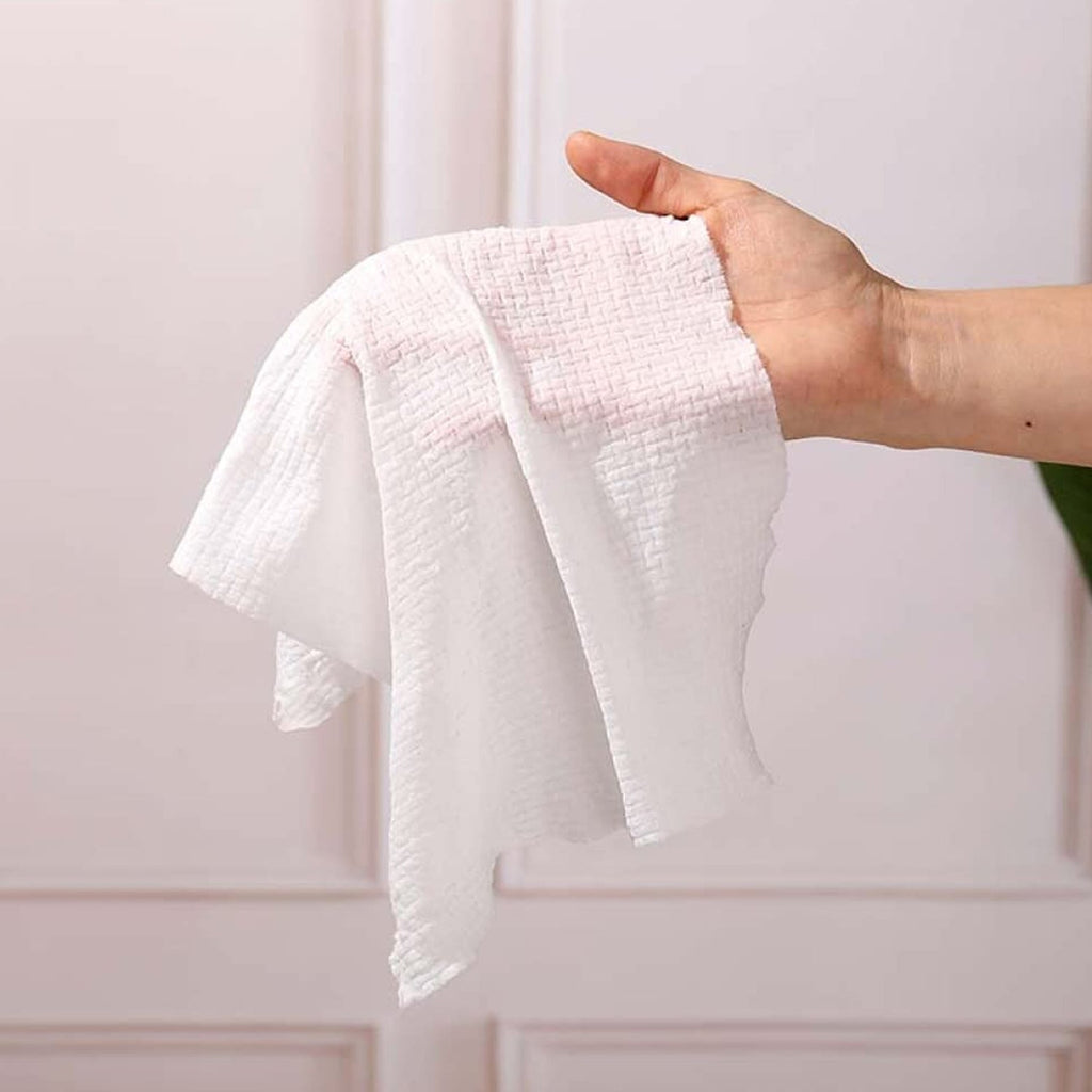 Person using a disposable travel towel outdoors for hygiene.