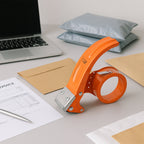 Close-up of the sharp steel blade on a 50mm packing tape dispenser.