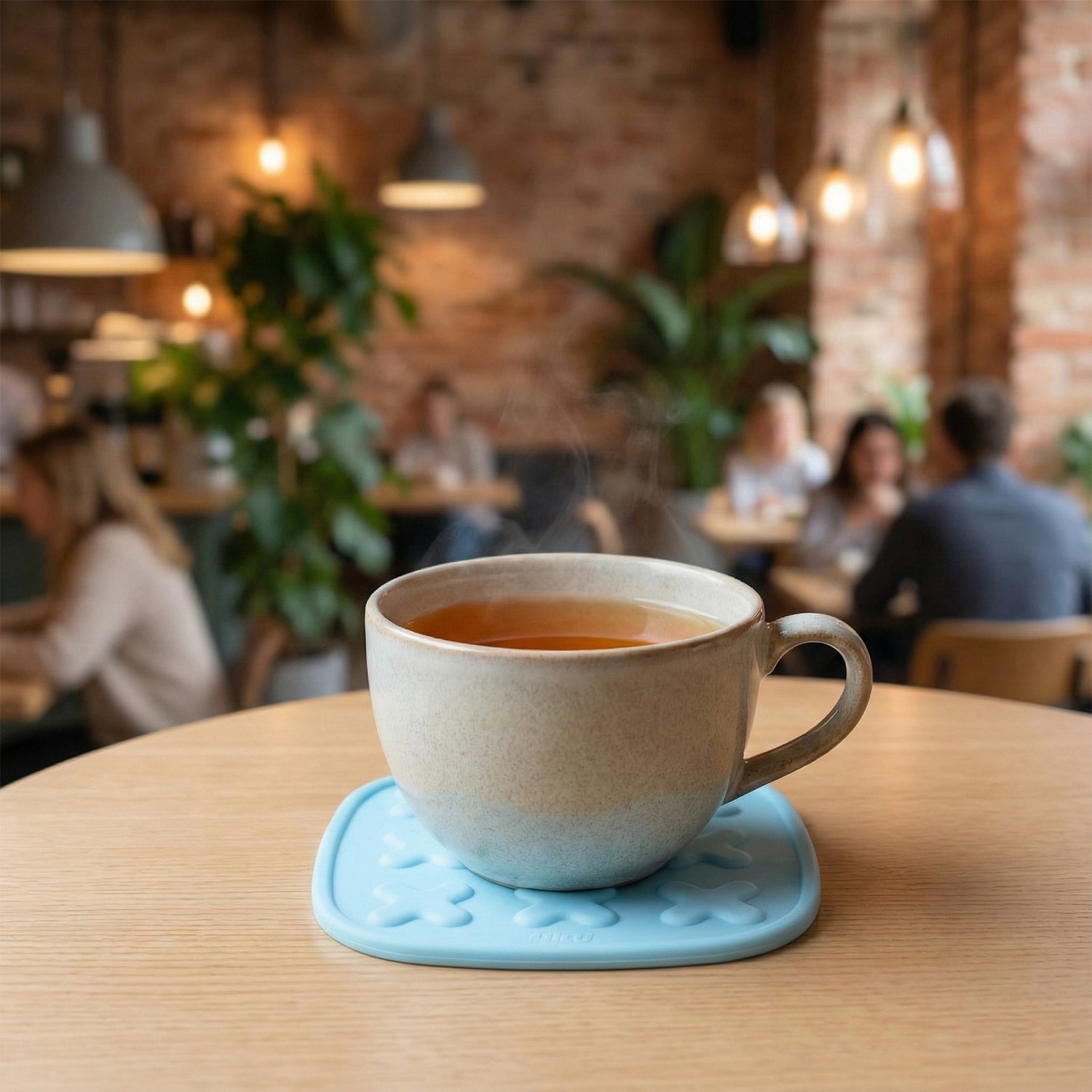 Heat-resistant coaster shielding a wooden table from hot pot heat marks