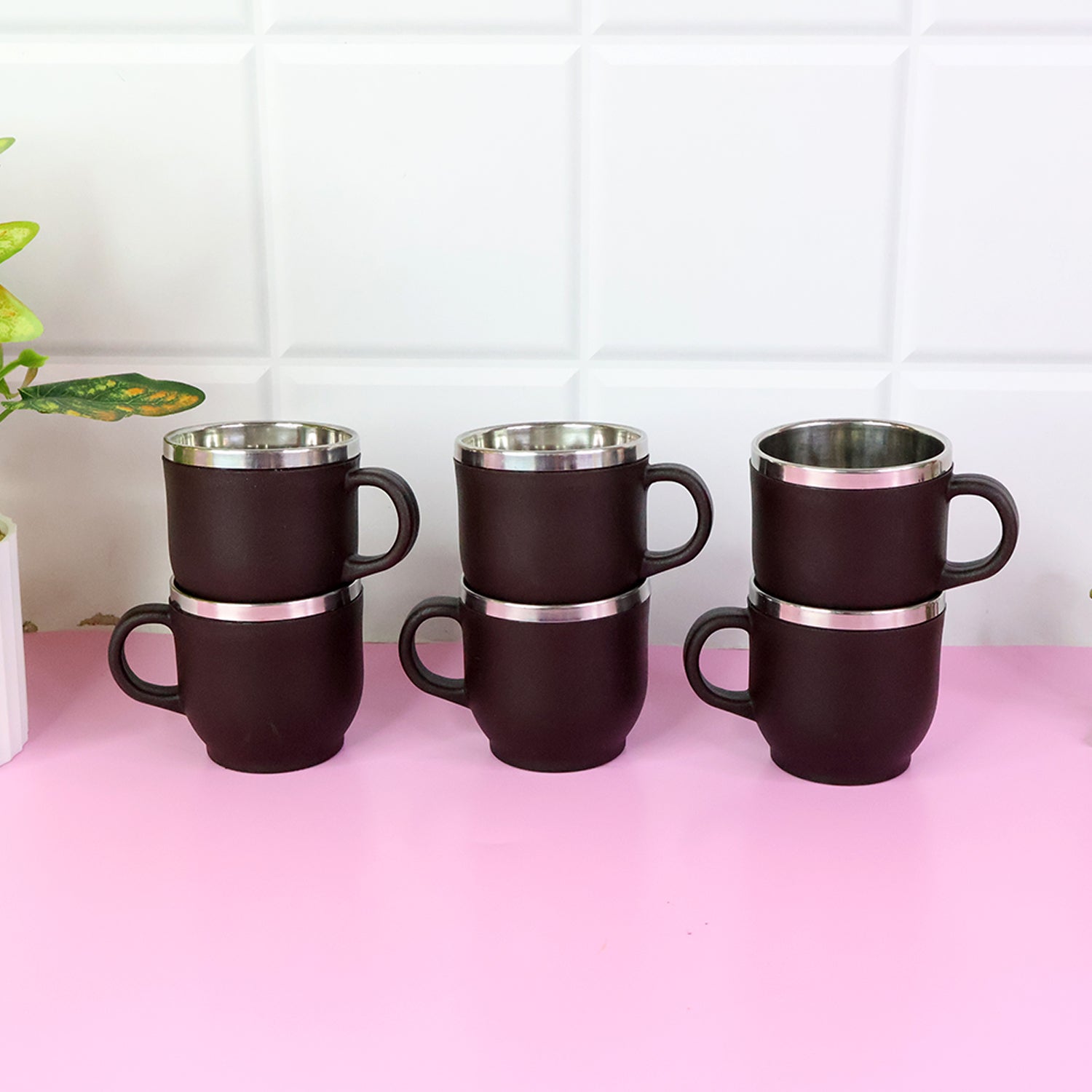 Close-up of ergonomic handle on stainless steel cappuccino mug with double wall design