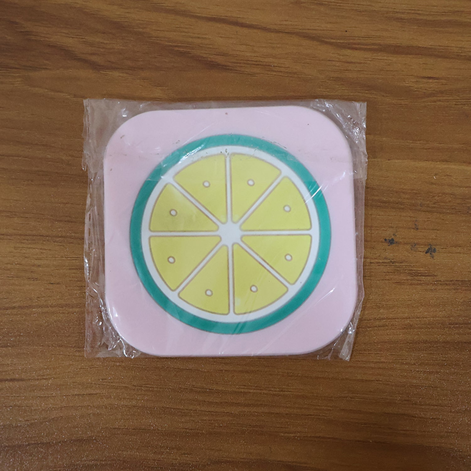 Stacked silicone fruit coasters including lemon design for table protection
