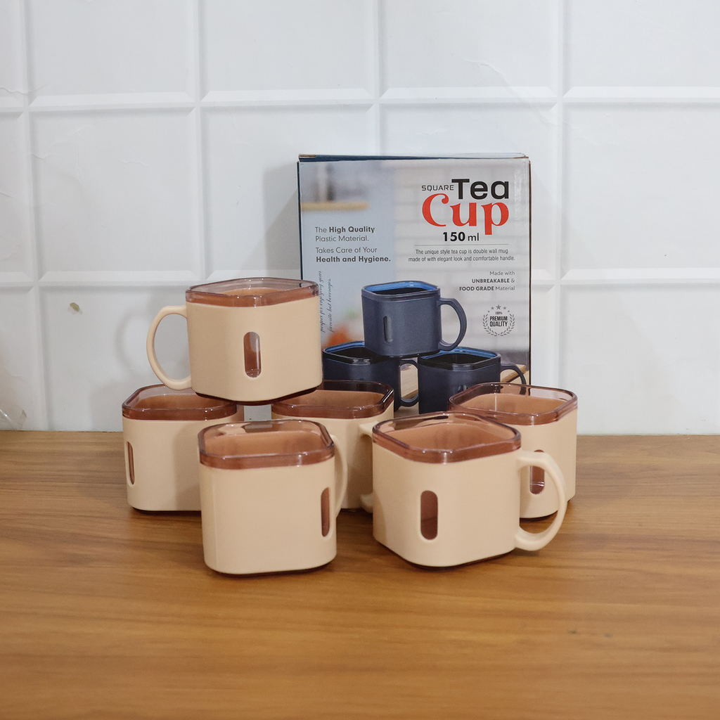 Square tea cup held in hand highlighting transparent rim