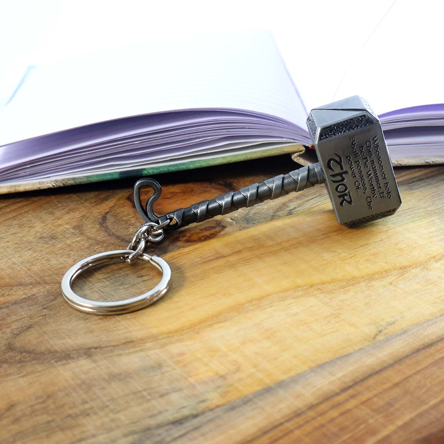 Stylish metal hammer keychain held in hand showing design