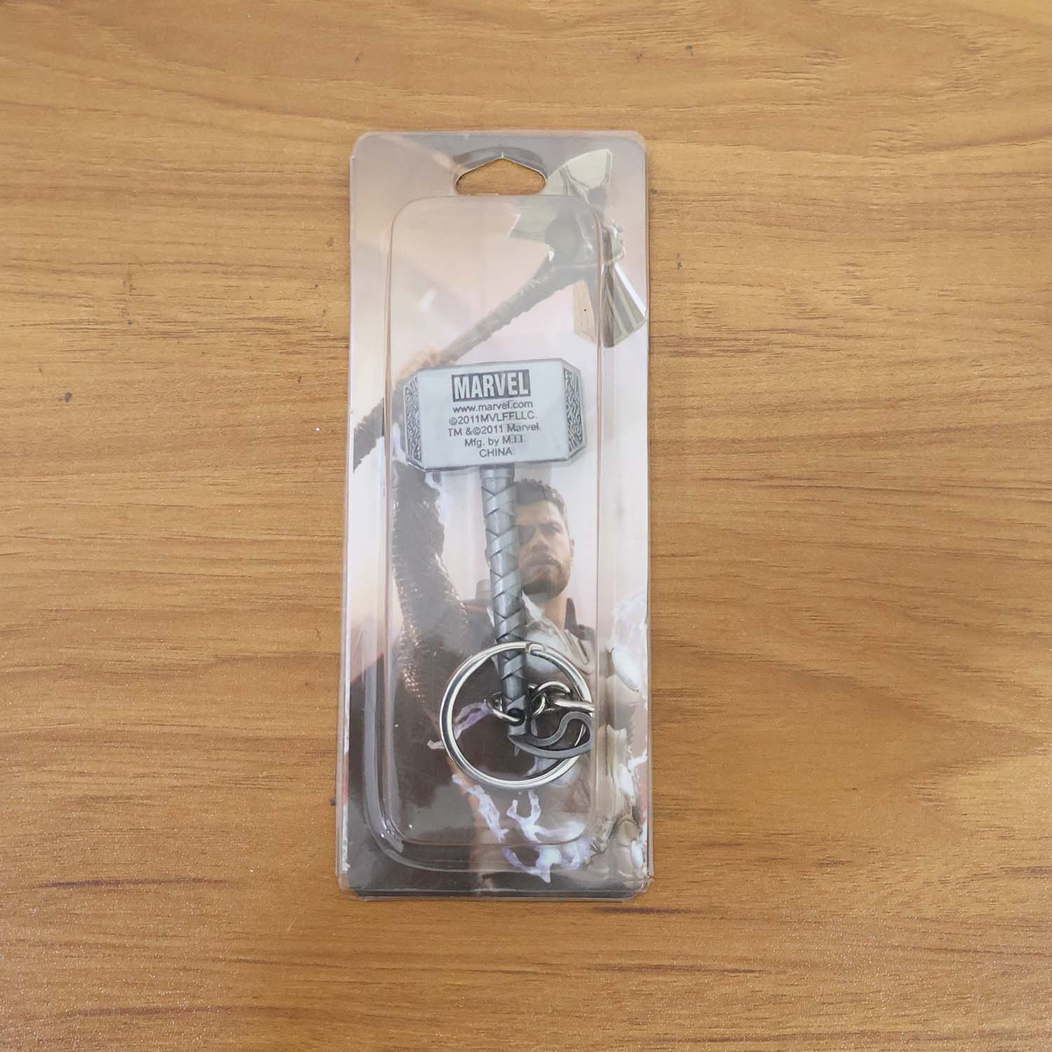 Metal hammer keychain displayed on a flat surface
