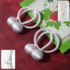 Magnetic curtain tiebacks in use, holding a grey curtain securely.