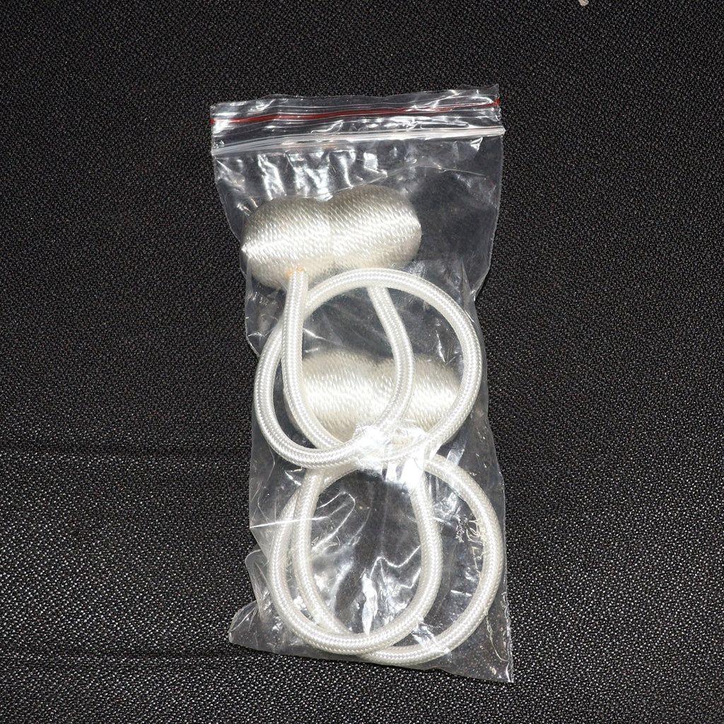 Elegant magnetic curtain tiebacks in a home setting, styling a window.