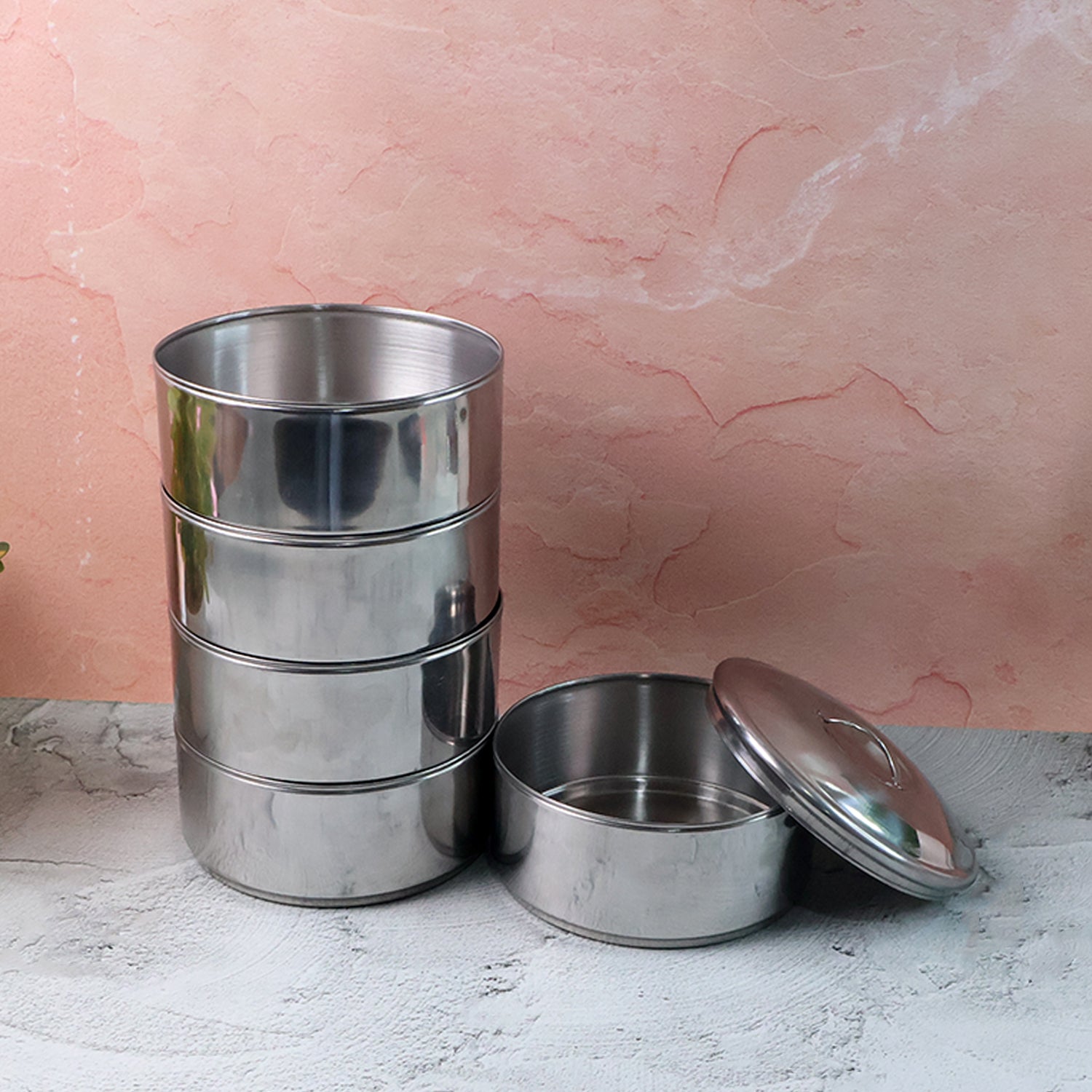 Empty round stainless steel lunch box, highlighting its clean design.