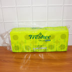 A Freshee toilet tissue roll being used from a holder, showing ease of dispensing.