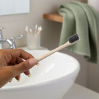 The MintGuard Soft-bristle Toothbrush resting on a clean bathroom counter, ready for use.