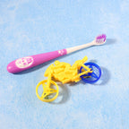 Panda kids toothbrush with ergonomic grip and motorcycle toy