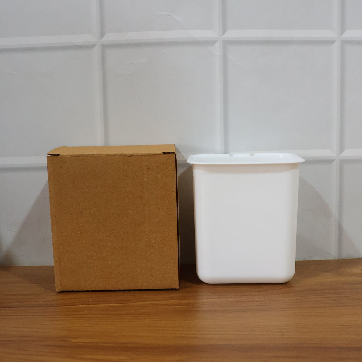 Lifestyle image of wall mounted toothbrush holder in use inside a real bathroom.