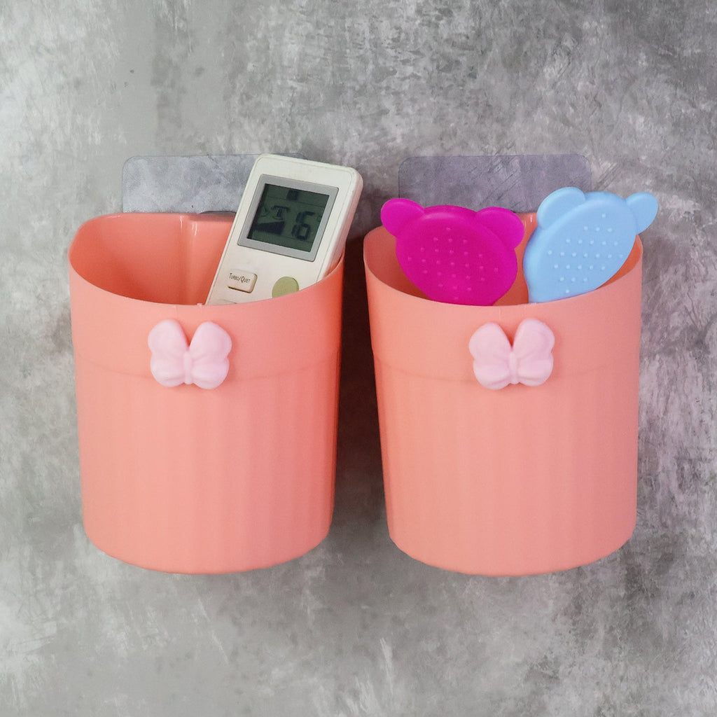 Close-up view of butterfly design wall-mounted toothbrush holder with two toothbrushes inside