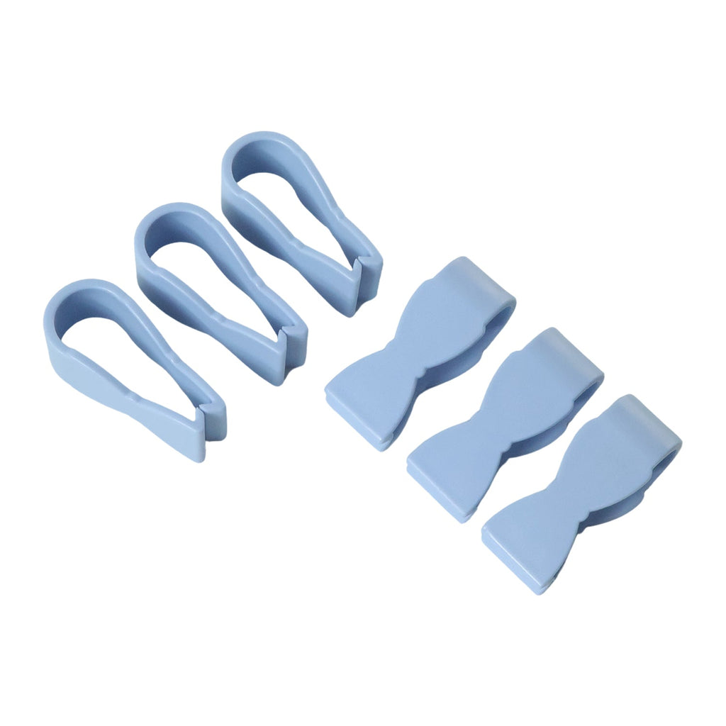 White towel clips securing a towel on a bathroom bar