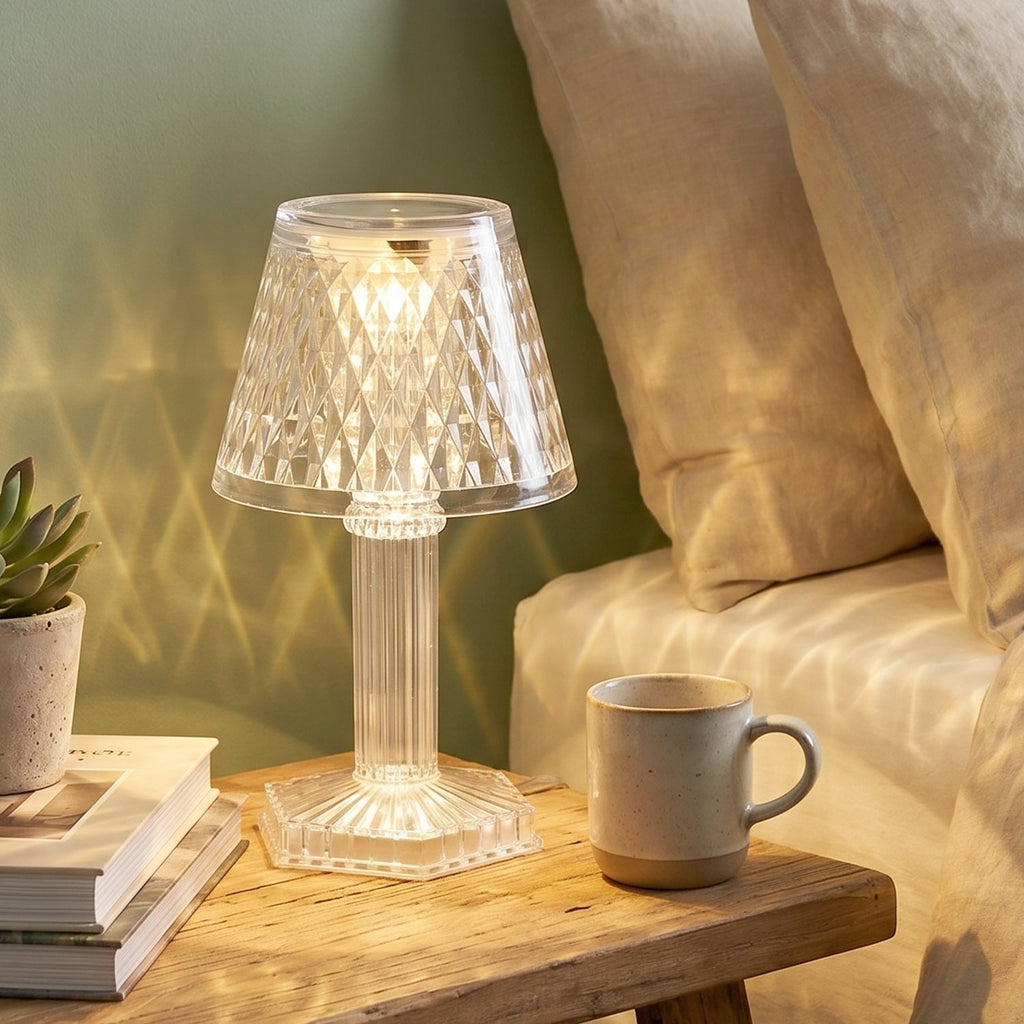 Crystal table lamp casting a beautiful patterned light on a wall.