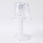 Modern LED crystal lamp displayed on a wooden shelf in a home setting.