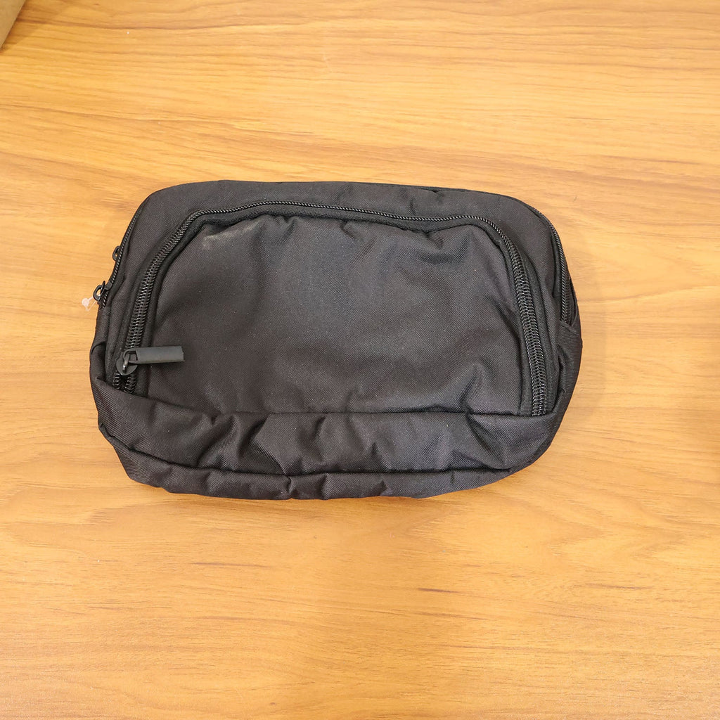 Lifestyle image showing small electronics organizer pouch in use