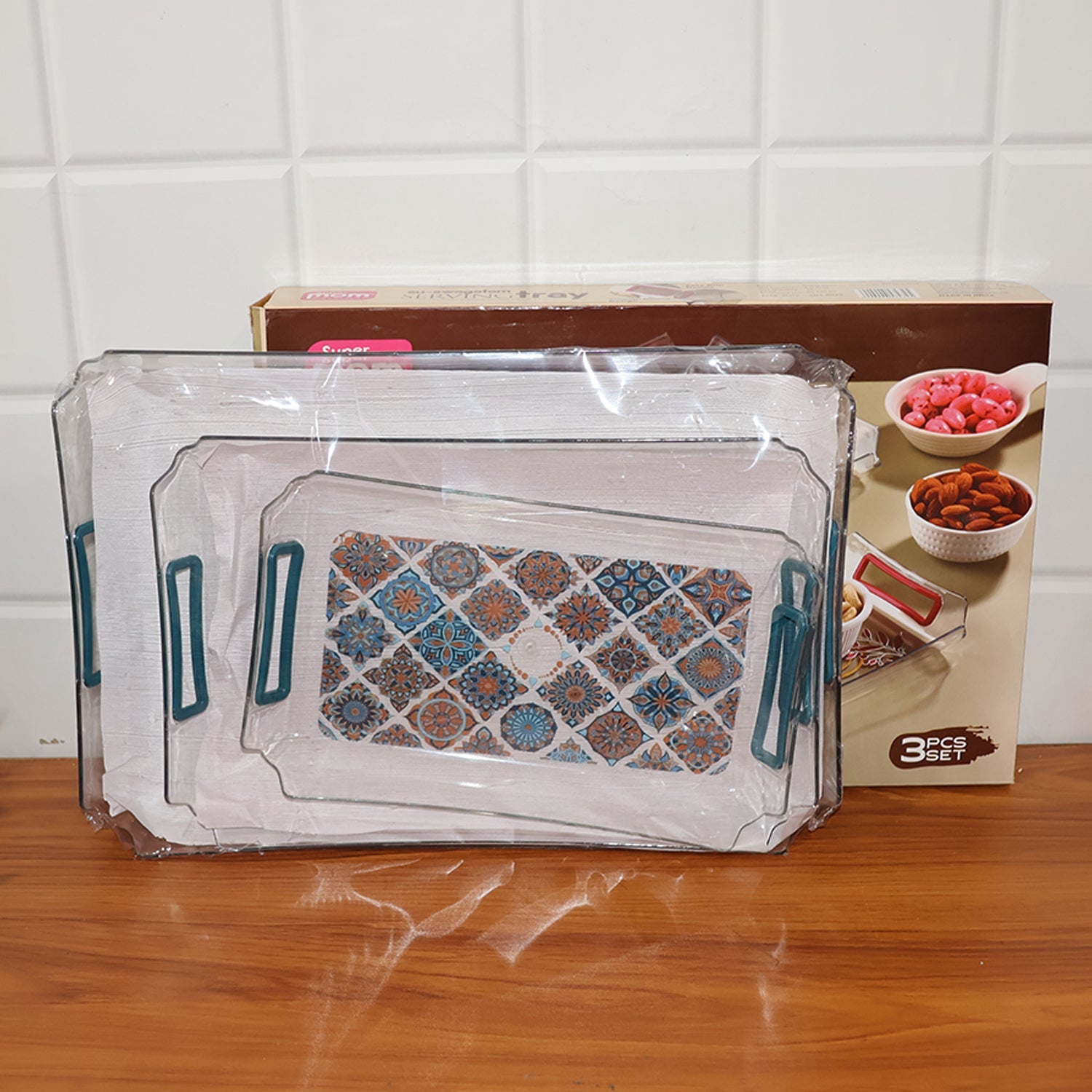 Compact stacking of three versatile serving trays with raised edges and handles