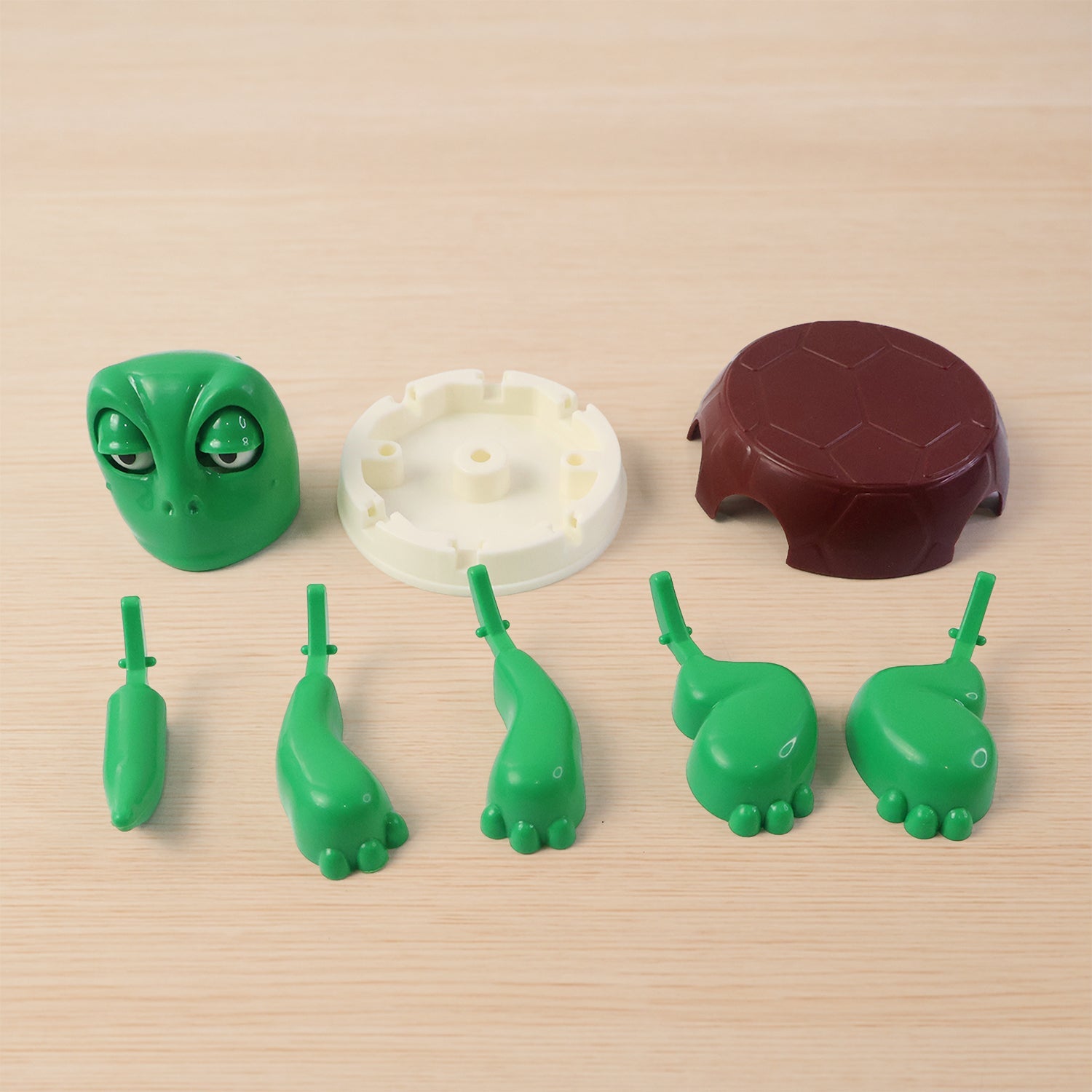 Plastic turtle coaster protecting office desk from spills
