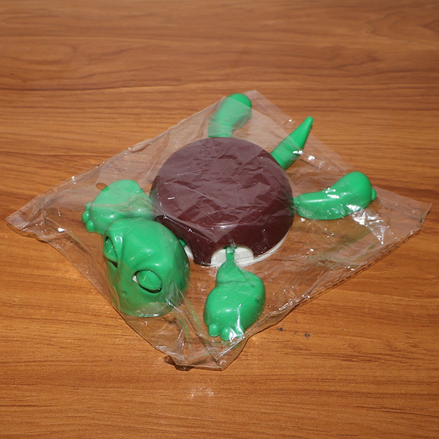 Reusable plastic turtle cup coaster holding a small container