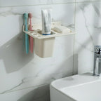 Soap tray with drainage holes in the wall mounted toothbrush holder keeping soap dry.